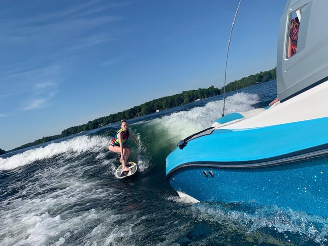 wakesurfing and being towed by a boat